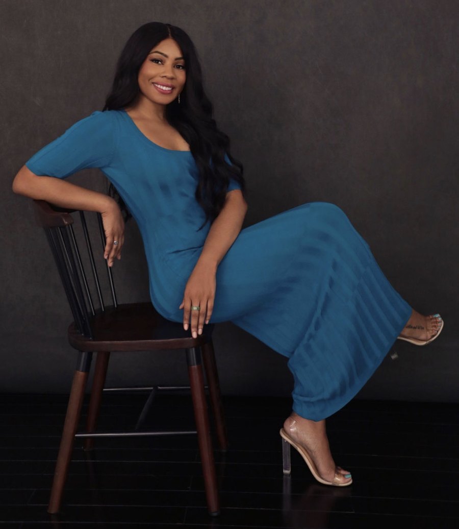 Karren Hodge, founder of Innovating Good, seated in a blue dress