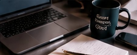 Laptop, notebook, and an Innovating Good mug on a desk